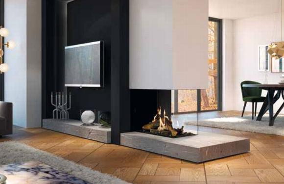 Three sided gas fire in middle of modern open plan living room as part of a media wall