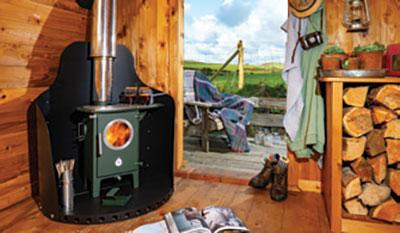 green stove in corner of cabin